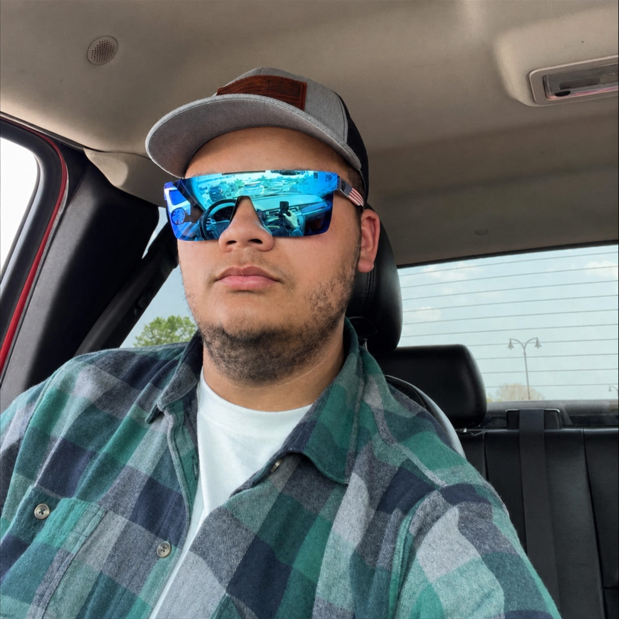 Tristan Riley Jensen wearing a cap and blue sunglasses
